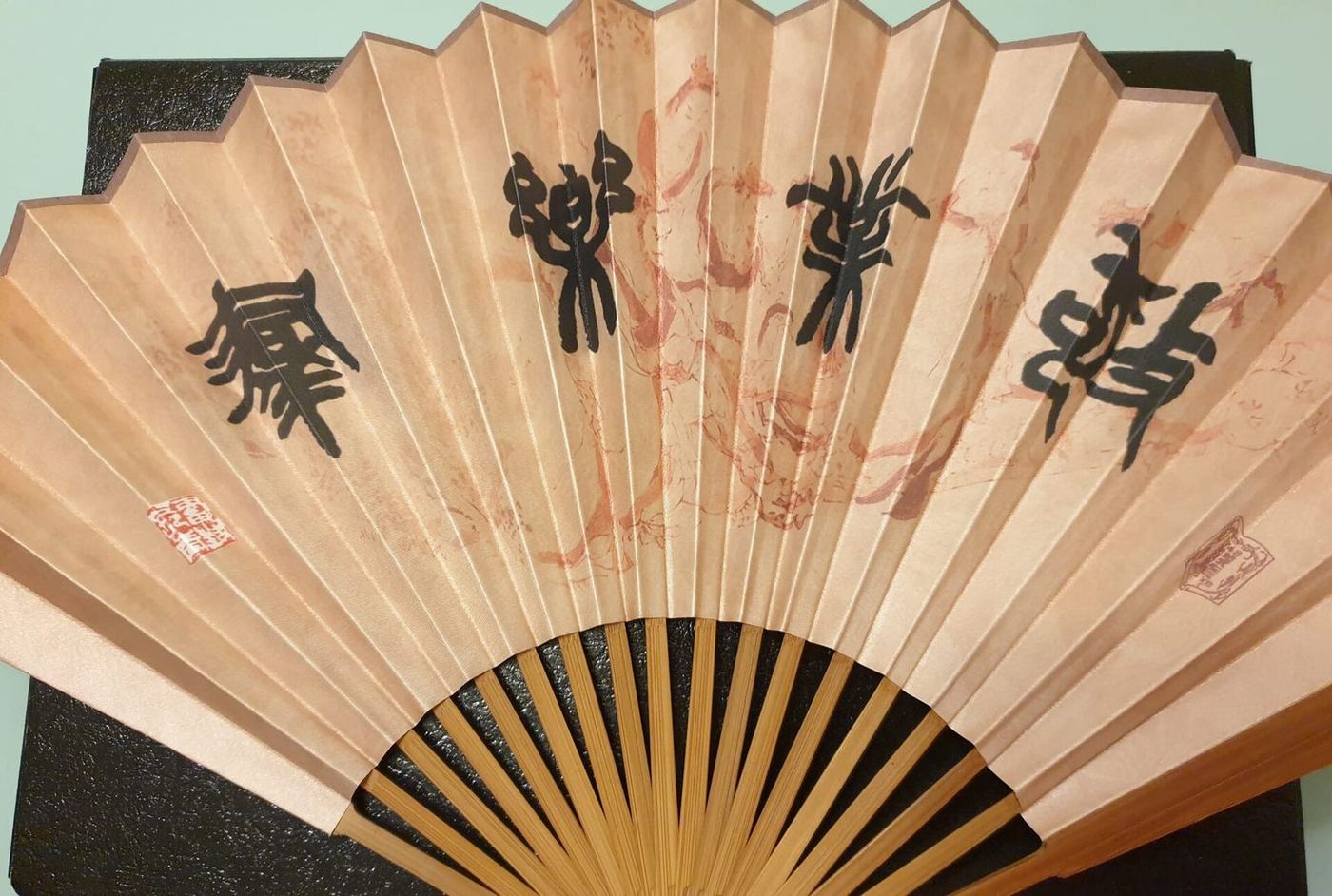 Fan with bamboo ribs and a cloth leaf