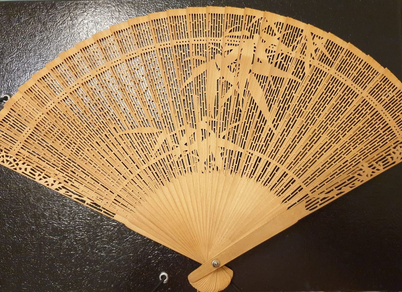 Folding fan with bamboo ribs and a painted paper leaf