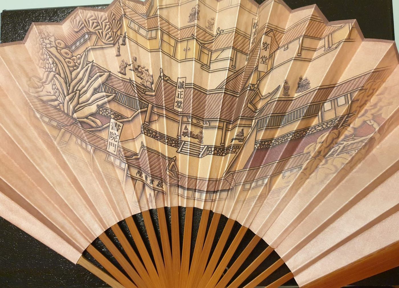 Folded fan with pale bamboo ribs