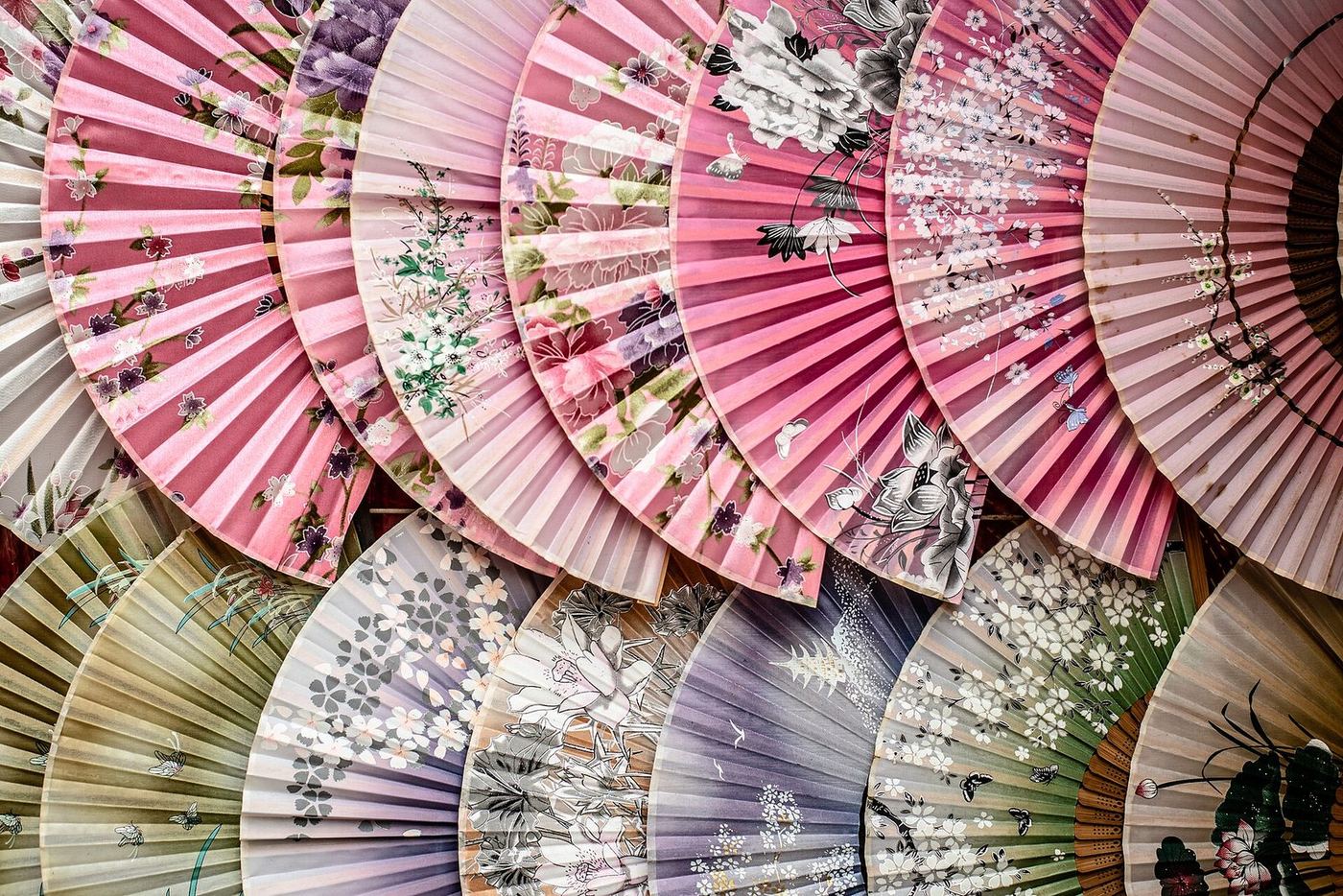 Rows of traditional Chinese fans for sale in a Chinatown shop window