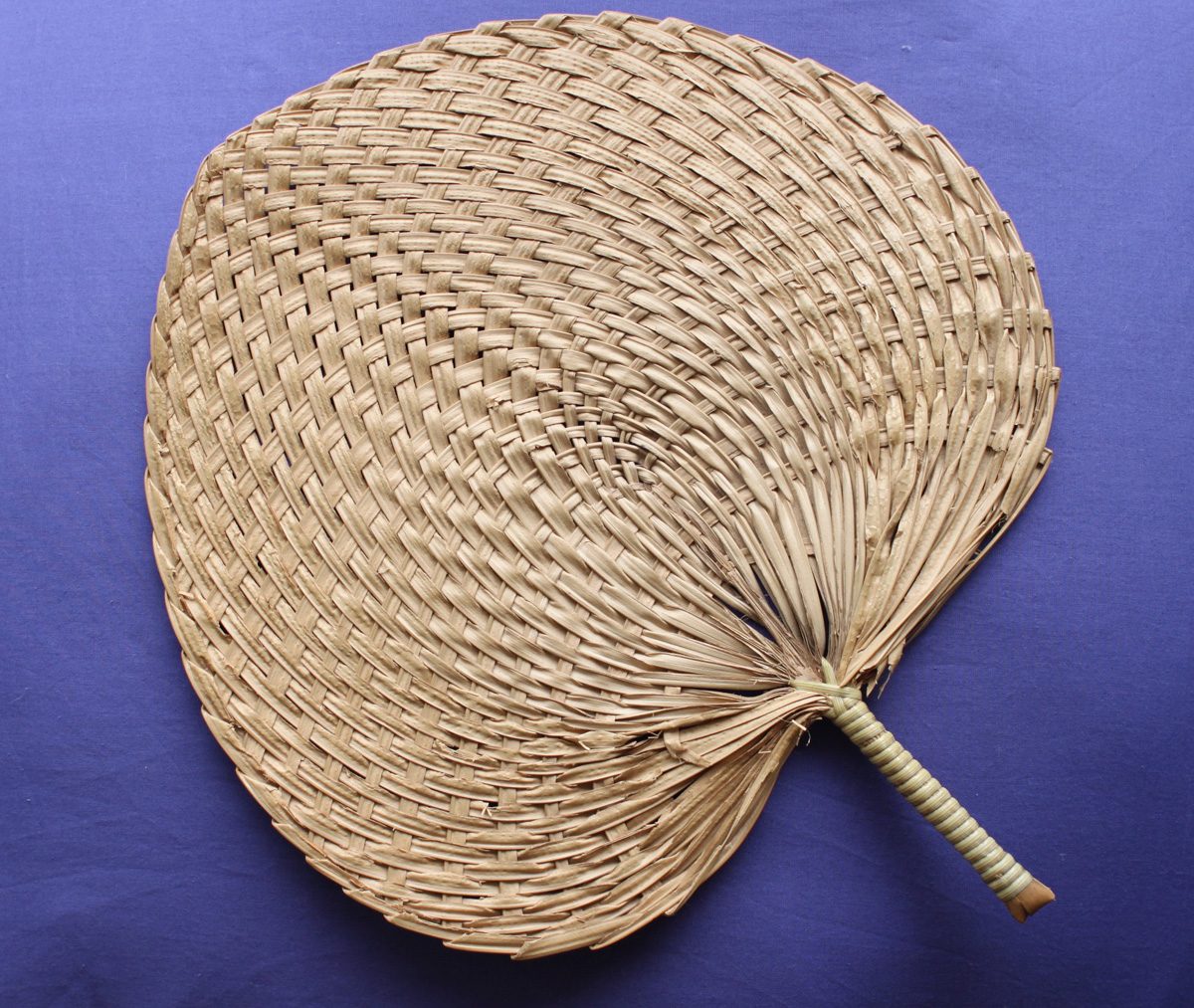 Chinese palm leaf fan with a painted surface and carved handle